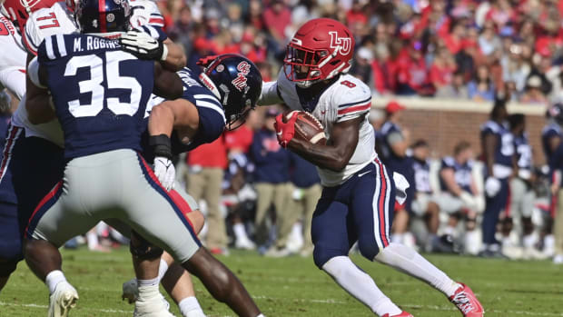 Nov 6, 2021; Oxford, Mississippi, USA;Liberty Flames running back Joshua Mack (8) runs the ball against the Mississippi Rebels during the first quarter at Vaught-Hemingway Stadium. Mandatory Credit: Matt Bush-USA TODAY Sports